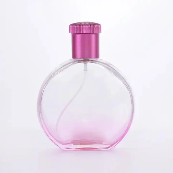 Flacone di profumo rotondo rosa da 100 ml con tappo a baionetta in acrilico e spruzzatore in alluminio dorato